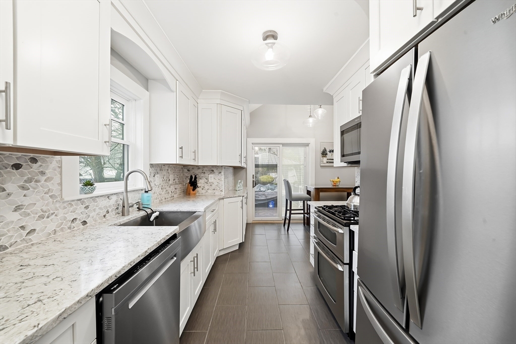 4 Wescott Road Stoneham, MA 02180 - Photo 19 of 42 a kitchen with stainless steel appliances granite countertop a refrigerator a stove a sink and dishwasher
