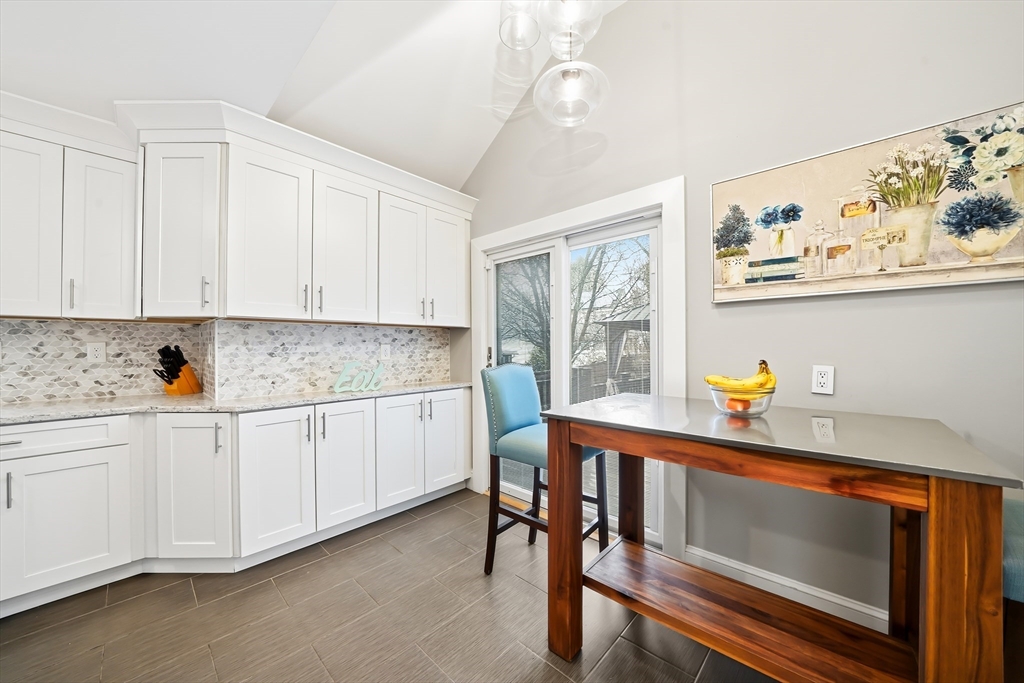 4 Wescott Road Stoneham, MA 02180 - Photo 21 of 42 a kitchen with stainless steel appliances white cabinets and wooden floors