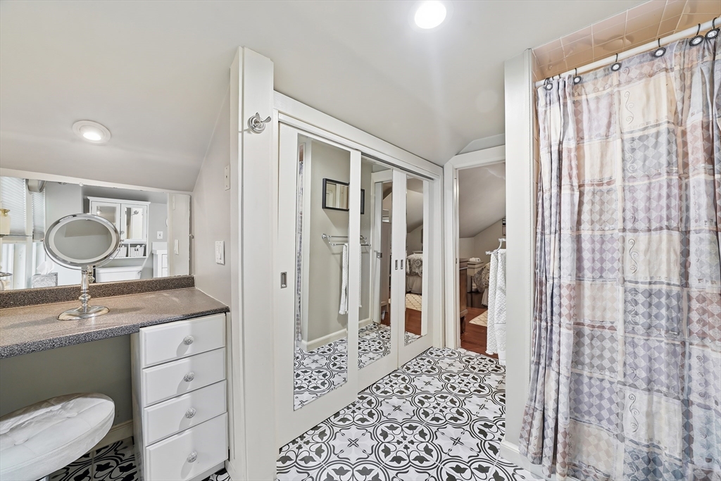 4 Wescott Road Stoneham, MA 02180 - Photo 26 of 42 a bathroom with a granite countertop sink a mirror a vanity and a shower