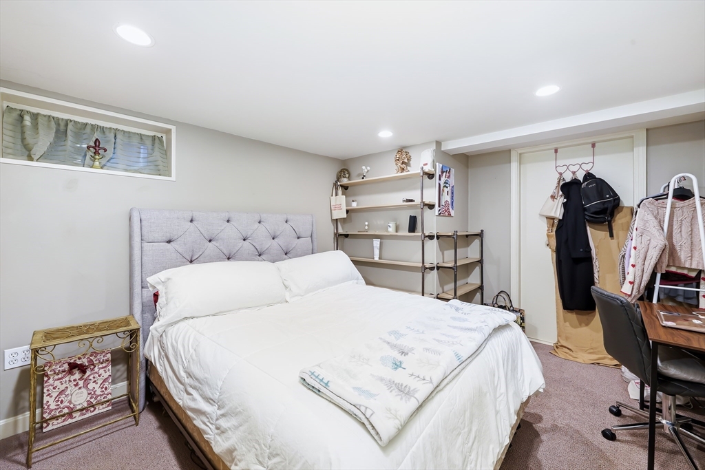 4 Wescott Road Stoneham, MA 02180 - Photo 29 of 42 a bedroom with a bed and a chair in it