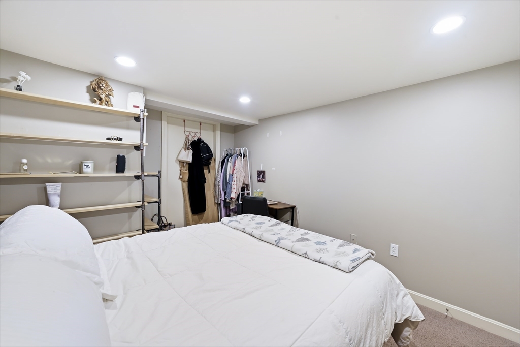 4 Wescott Road Stoneham, MA 02180 - Photo 30 of 42 a bed room with a bed and a large mirror