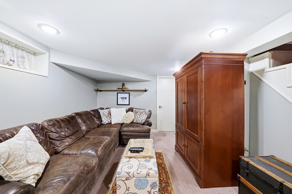 4 Wescott Road Stoneham, MA 02180 - Photo 33 of 42 a living room with furniture and a gate