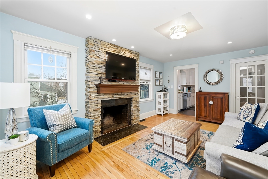 4 Wescott Road Stoneham, MA 02180 - Photo 8 of 42 a living room with furniture a flat screen tv and a fireplace