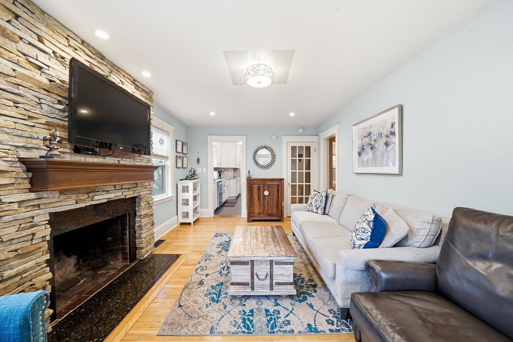 4 Wescott Road Stoneham, MA 02180 - Photo 9 of 42 a living room with furniture a flat screen tv and a fireplace