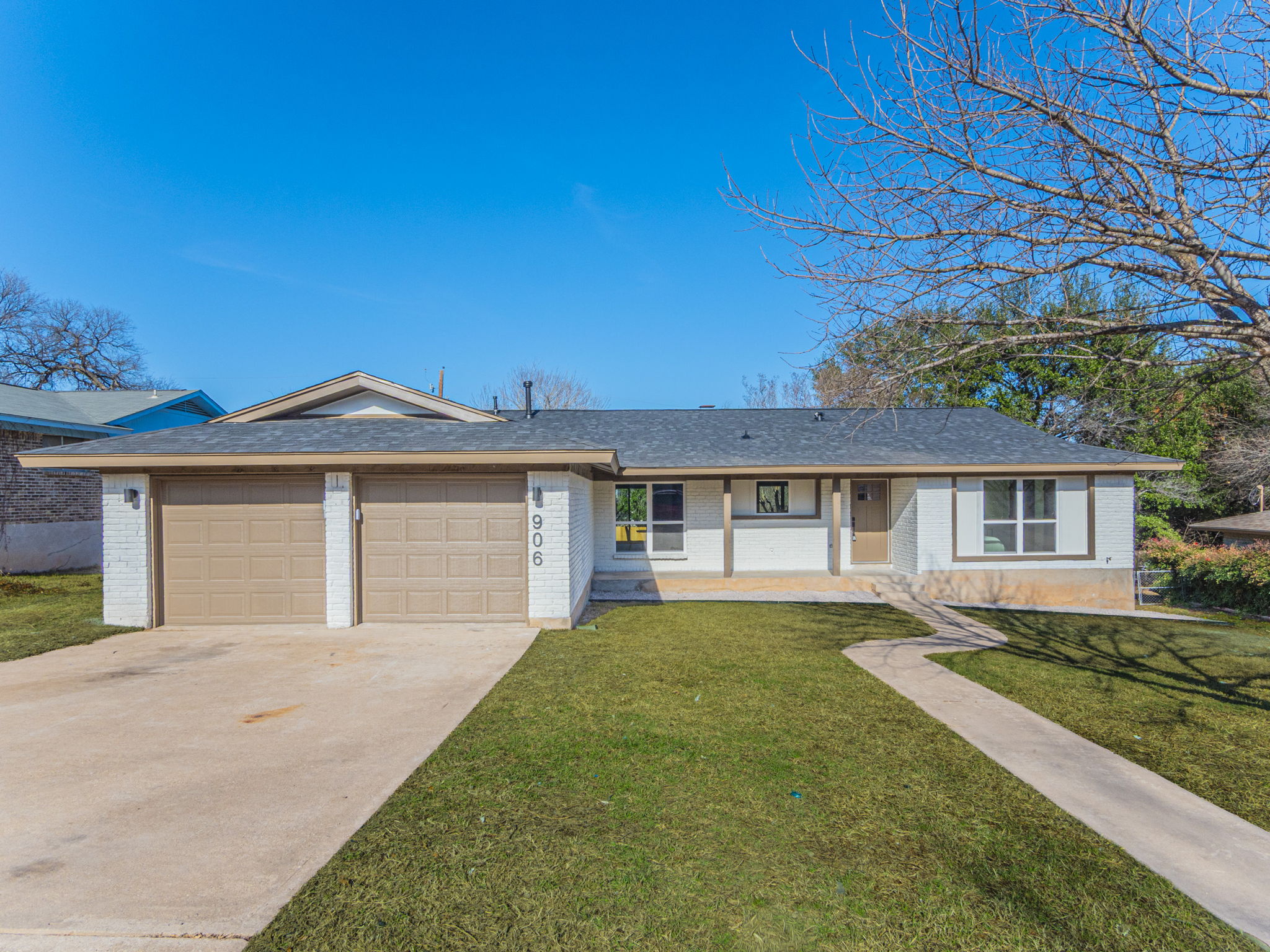 906 Fall Creek Drive Austin, TX 78753 - Photo 20 of 25 Ranch-style home with brick siding, driveway, a front lawn, a porch, and a garage