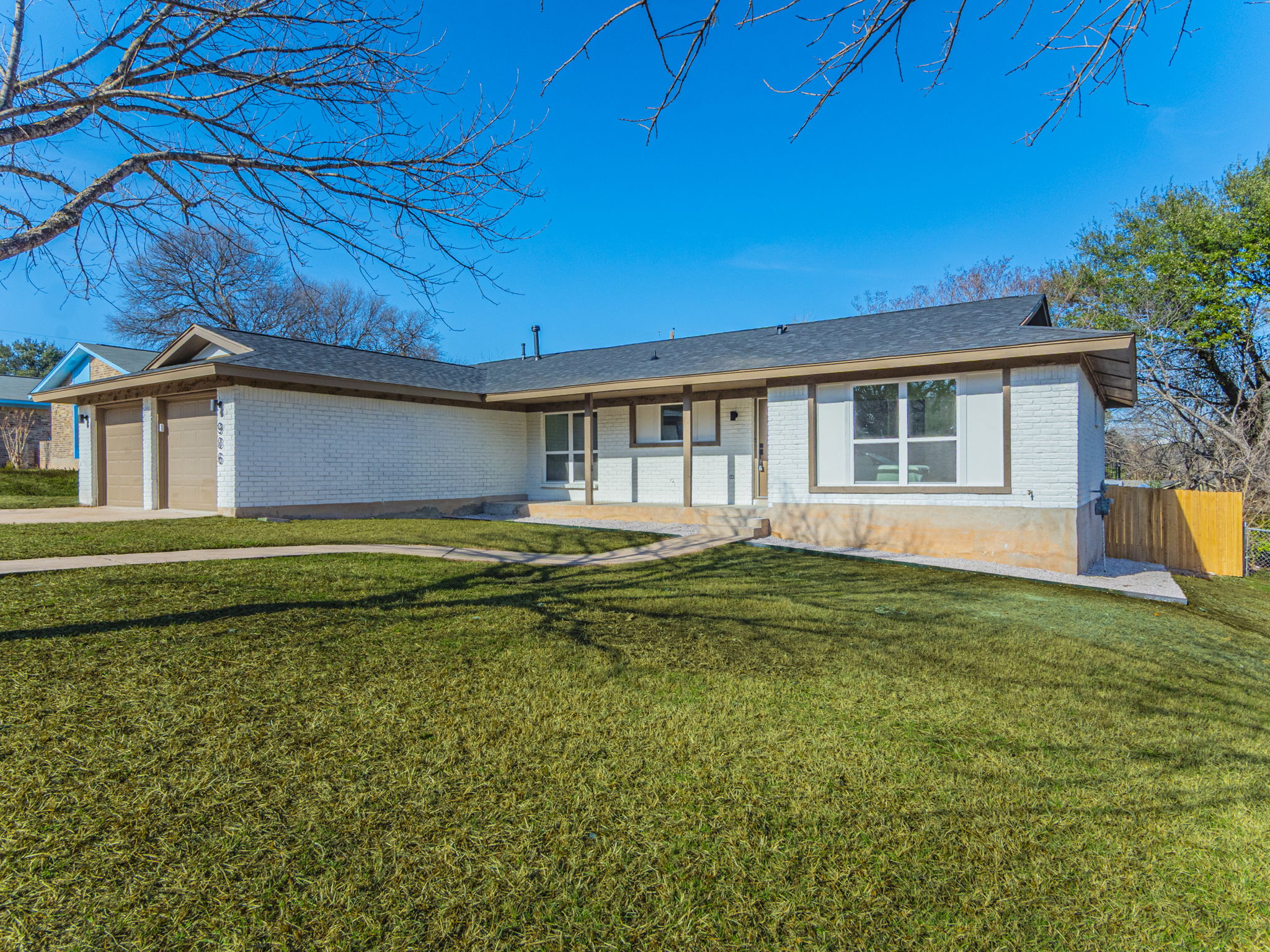 906 Fall Creek Drive Austin, TX 78753 - Photo 21 of 25 Ranch-style house featuring brick siding, an attached garage, and driveway