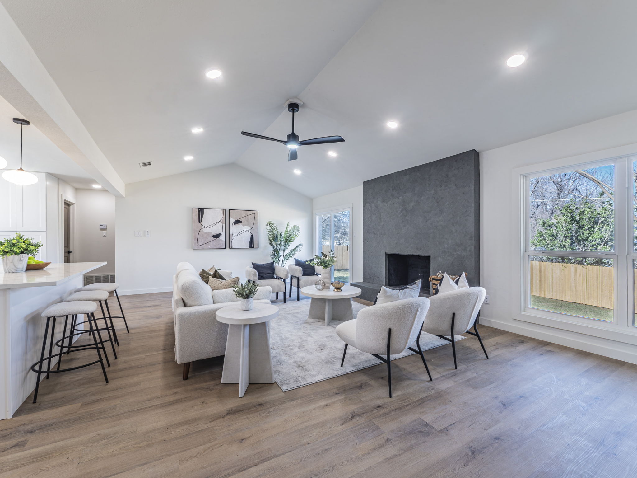 906 Fall Creek Drive Austin, TX 78753 - Photo 3 of 25 Living room with lofted ceiling, a large fireplace, light wood-style flooring, a ceiling fan, and recessed lighting
