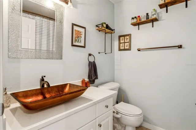 a bathroom with a sink a toilet and mirror