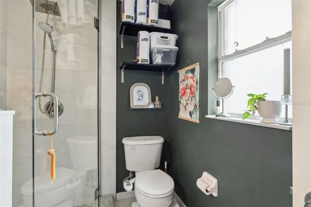 a white toilet sitting next to a bathroom sink