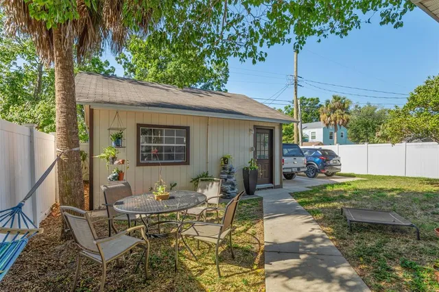 a view of a patio with table and chairs and potted plants
