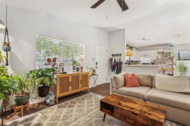 a living room with furniture and a potted plant