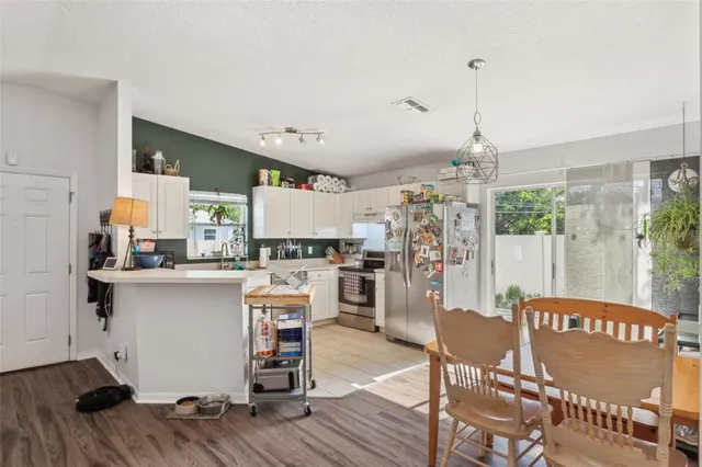 a open kitchen with stainless steel appliances granite countertop a stove and refrigerator