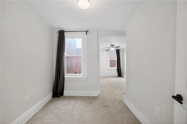 an empty room with windows and closet