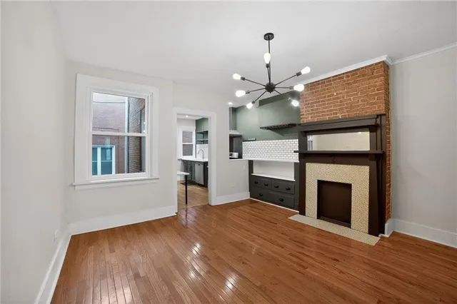 a view of an empty room with a fireplace and a window