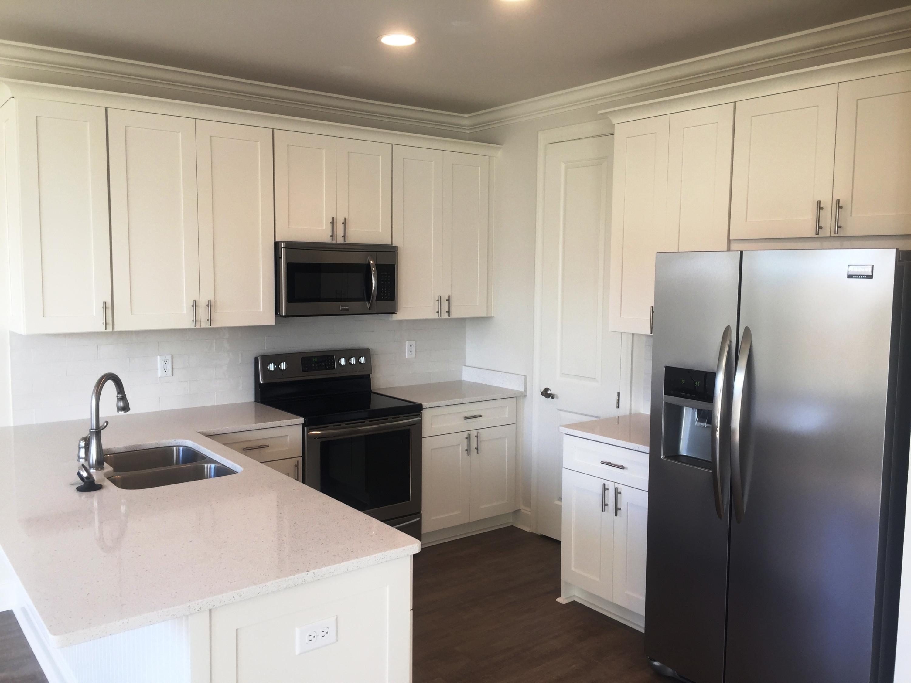 64 Chapman Street Santa Rosa Beach, FL 32459 - Photo 7 of 31 a kitchen with a sink a stove and refrigerator