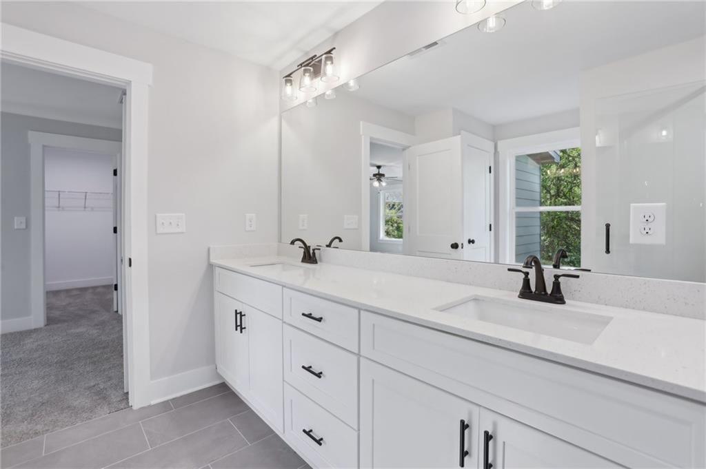 992 Coleman Street Southwest Atlanta, GA 30310 - Photo 16 of 18 a bathroom with double vanity sink and a mirror