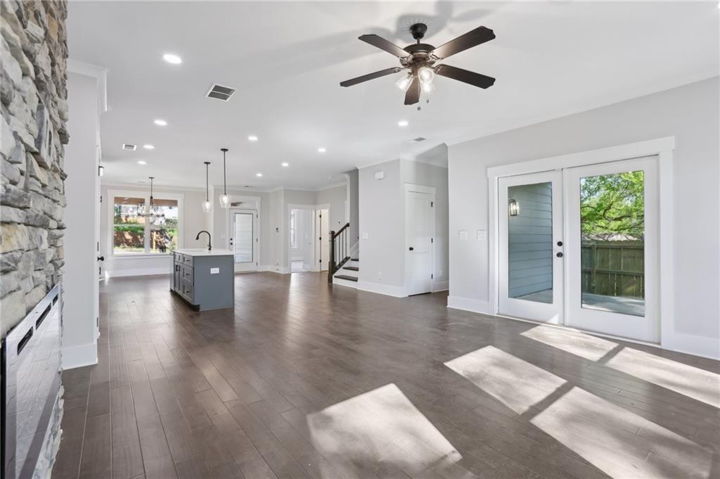 992 Coleman Street Southwest Atlanta, GA 30310 - Photo 7 of 18 a view of a big room with wooden floor and a kitchen