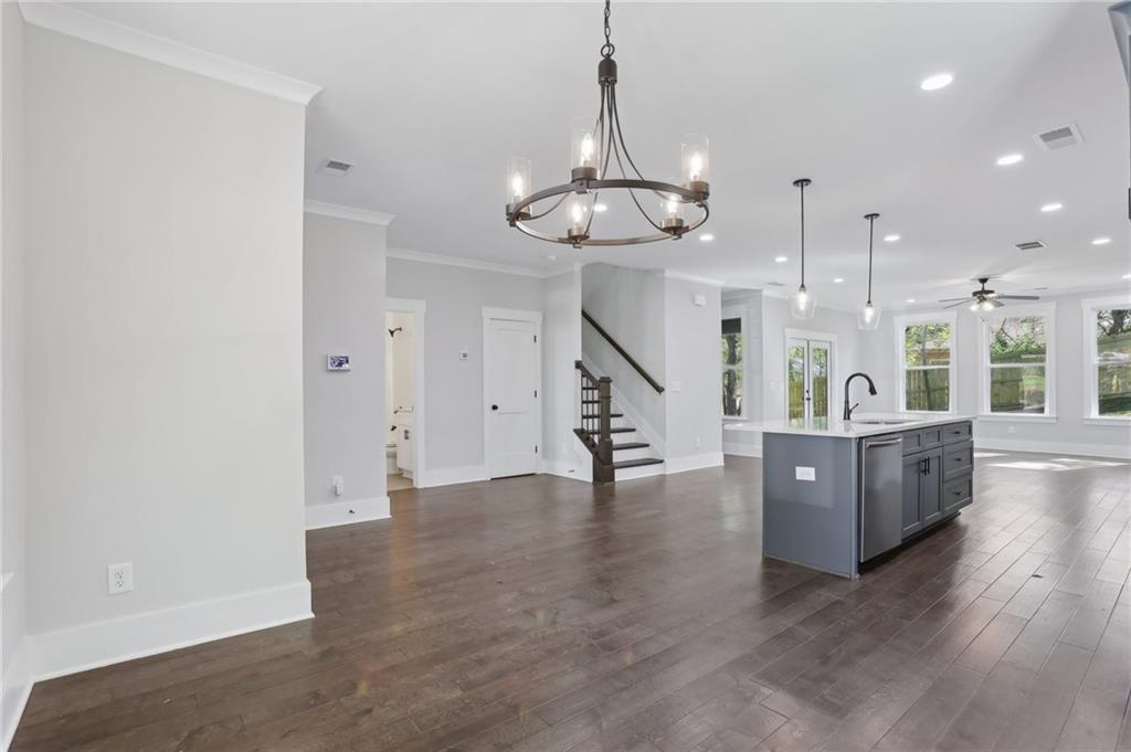 992 Coleman Street Southwest Atlanta, GA 30310 - Photo 8 of 18 a view of a living room and kitchen with wooden floor