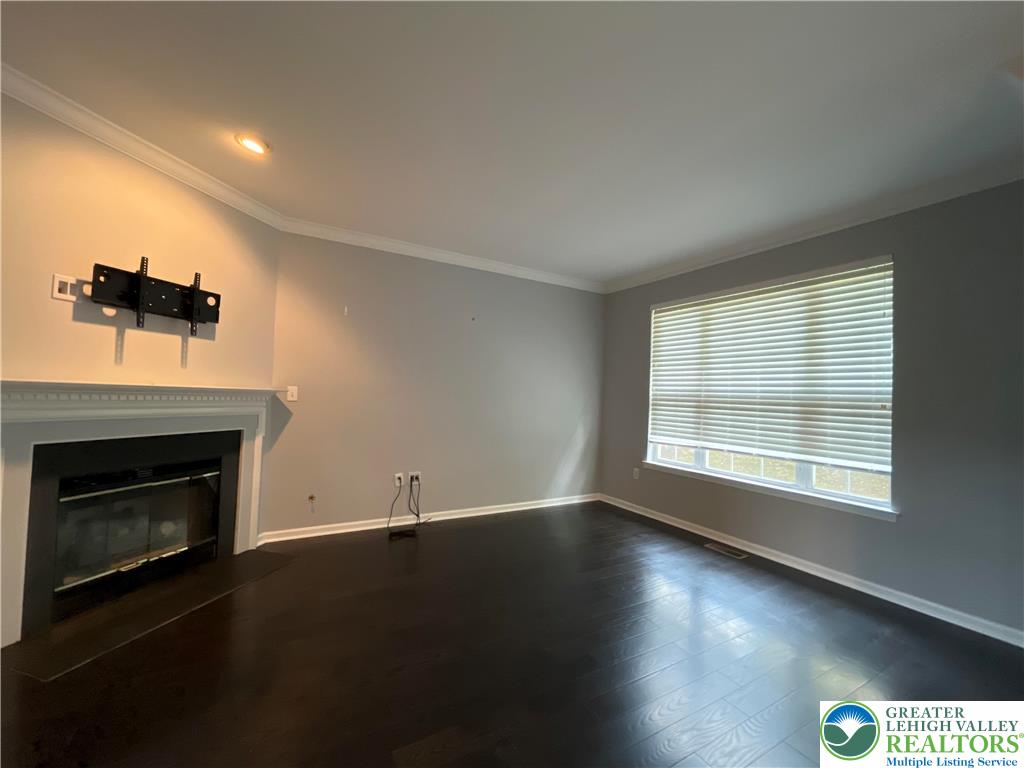 4224 Creek Road Allentown, PA 18104 - Photo 7 of 17 a view of empty room with wooden floor and fireplace
