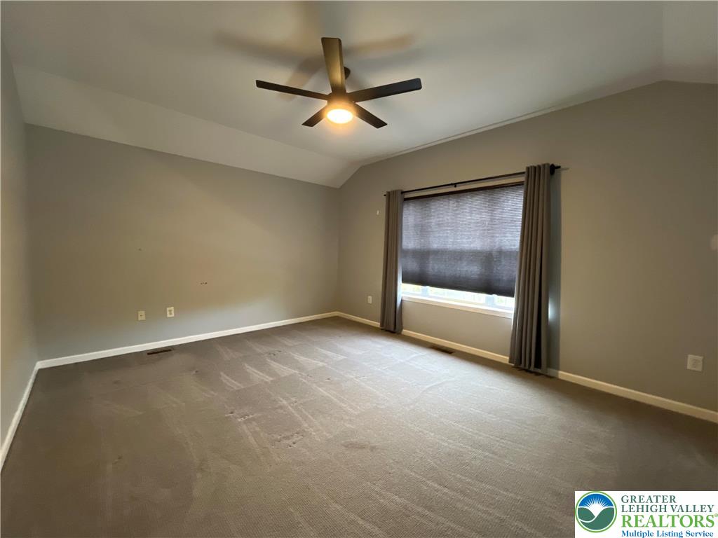 4224 Creek Road Allentown, PA 18104 - Photo 10 of 17 an empty room with a ceiling fan and window