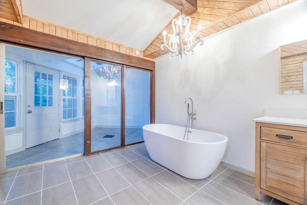 598 Stagecoach Trail Denison, TX 75021 - Photo 13 of 29 a spacious bathroom with a bathtub and shower