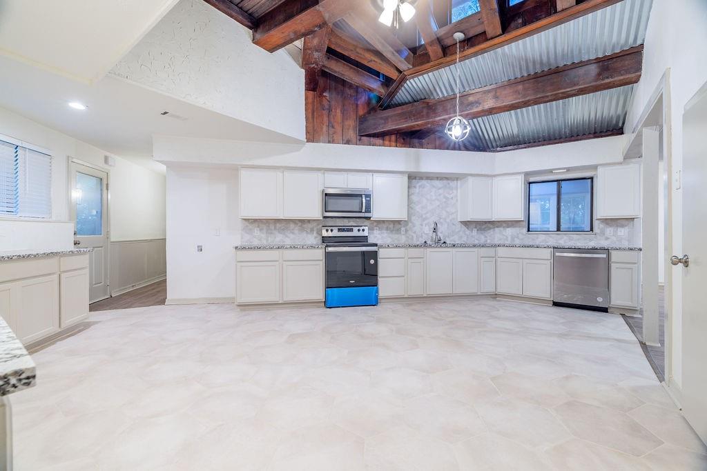 598 Stagecoach Trail Denison, TX 75021 - Photo 2 of 29 a kitchen with cabinets and stainless steel appliances