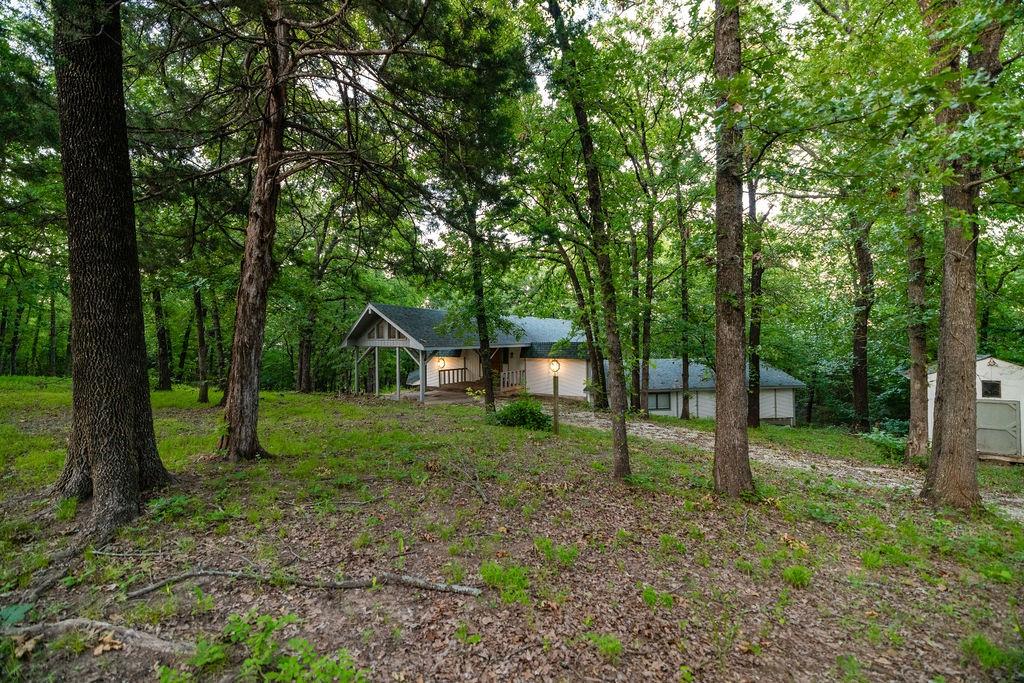 598 Stagecoach Trail Denison, TX 75021 - Photo 27 of 29 a view of a yard in a forest