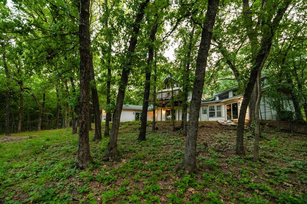 598 Stagecoach Trail Denison, TX 75021 - Photo 28 of 29 a backyard of a house with lots of green space