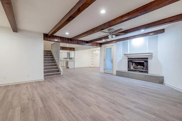 wooden floor in an empty room with a fireplace