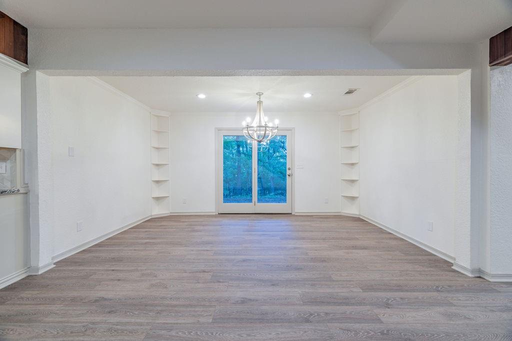 598 Stagecoach Trail Denison, TX 75021 - Photo 9 of 29 wooden floor in an empty room with a window