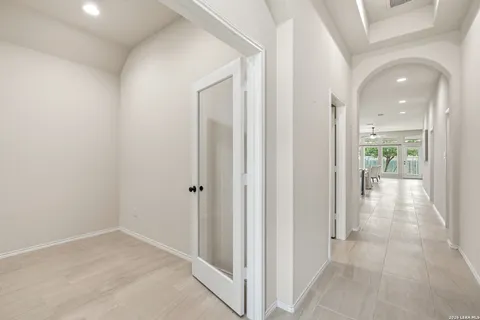 a view of a hallway with wooden floor