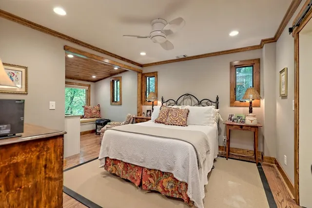 a bedroom with a bed window and couch