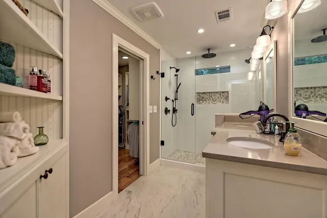 a bathroom with a sink double vanity and shower