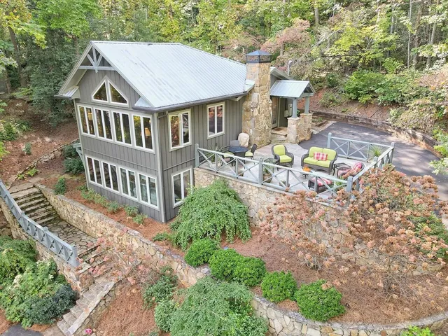 an aerial view of a house with backyard porch and furniture
