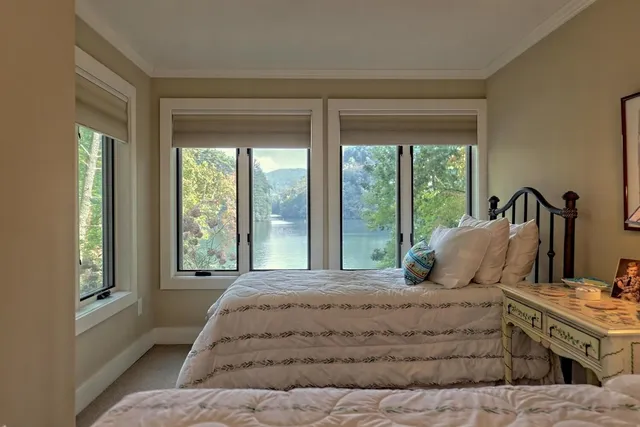 a bedroom with a large bed and a large window