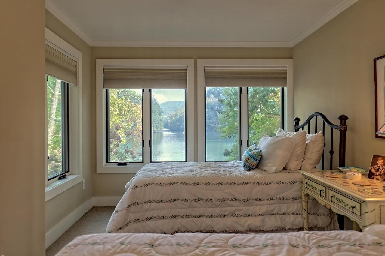 728 Oscar Rock Road Clayton, GA 30525 - Photo 22 of 40 a bedroom with a large bed and a large window