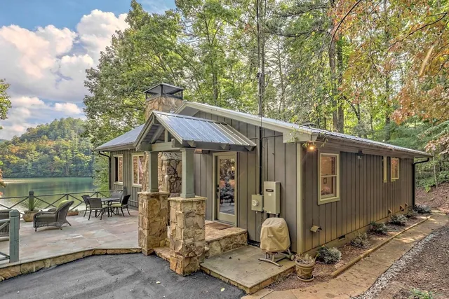 a view of backyard with a large tree and wooden fence