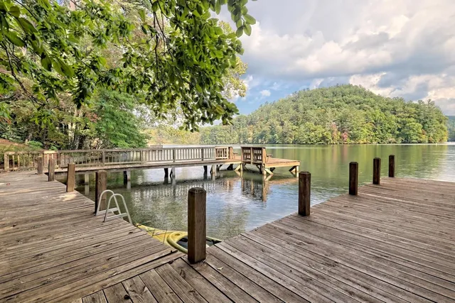 a view of a balcony with wooden floor and lake view