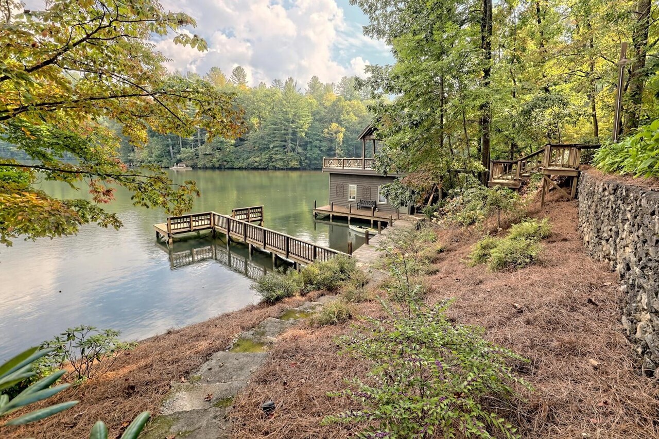 728 Oscar Rock Road Clayton, GA 30525 - Photo 4 of 40 a view of a lake with a bench and trees in the background