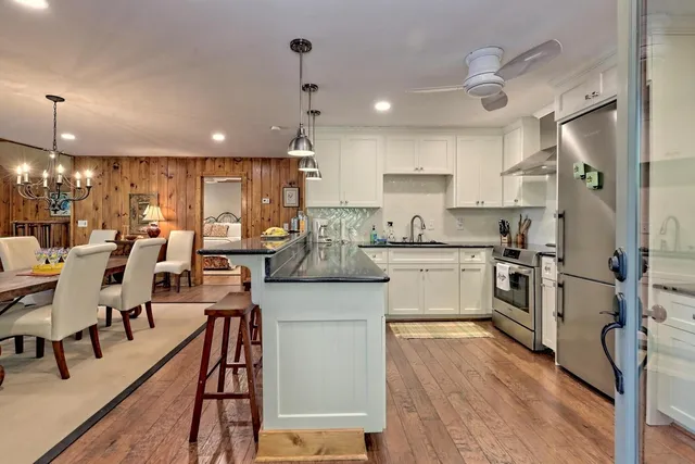 a kitchen with a sink stainless steel appliances and cabinets
