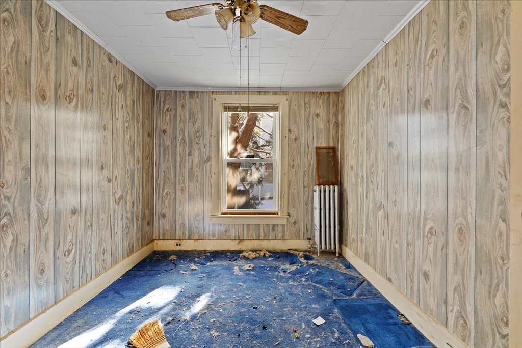 207 Hamilton Street Southbridge, MA 01550 - Photo 12 of 39 an empty room with wooden floor fan and windows