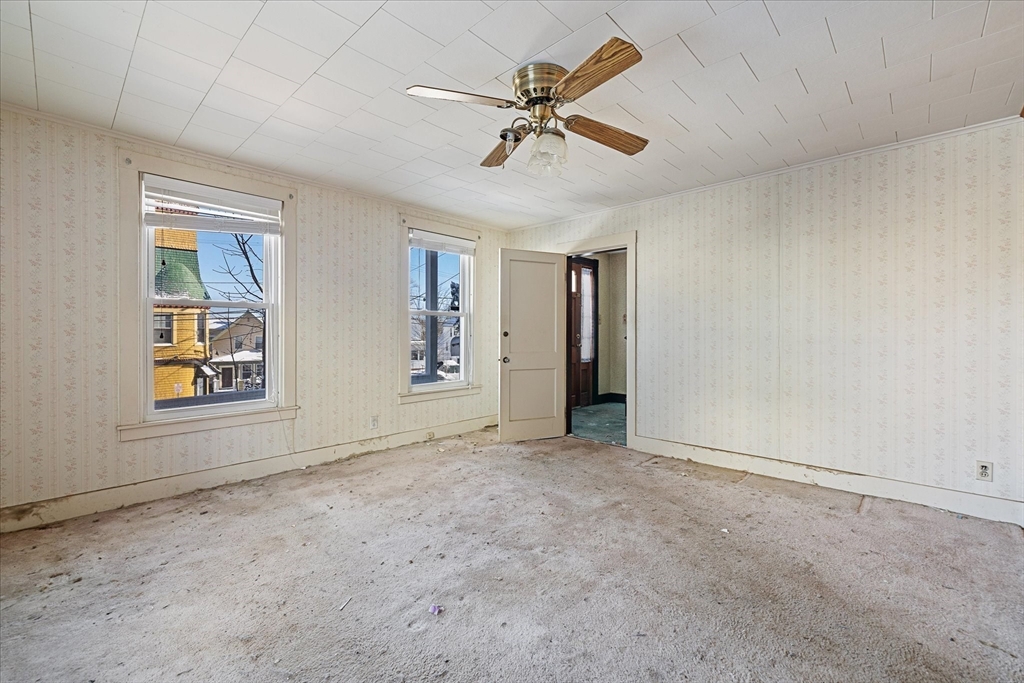 207 Hamilton Street Southbridge, MA 01550 - Photo 9 of 39 an empty room with windows and ceiling fan