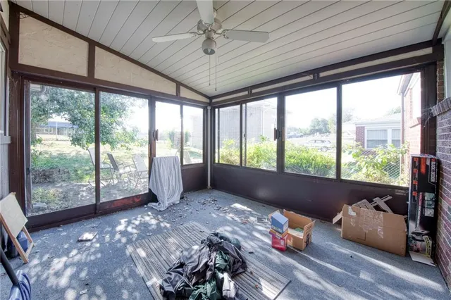 a living room with furniture and floor to ceiling windows