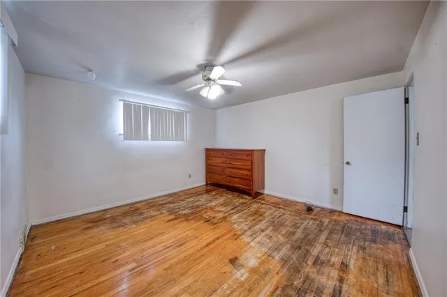 a view of a room with a ceiling fan and a window
