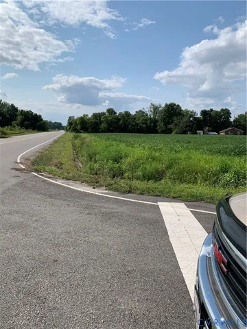a view of a garden with lawn chairs