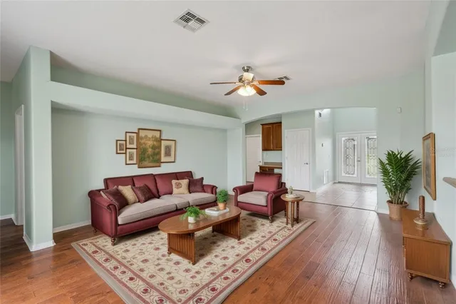 a living room with furniture and wooden floor