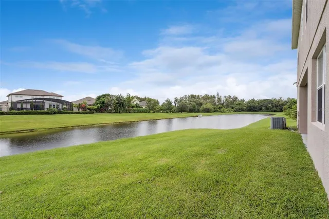 a view of a lake with houses in the background