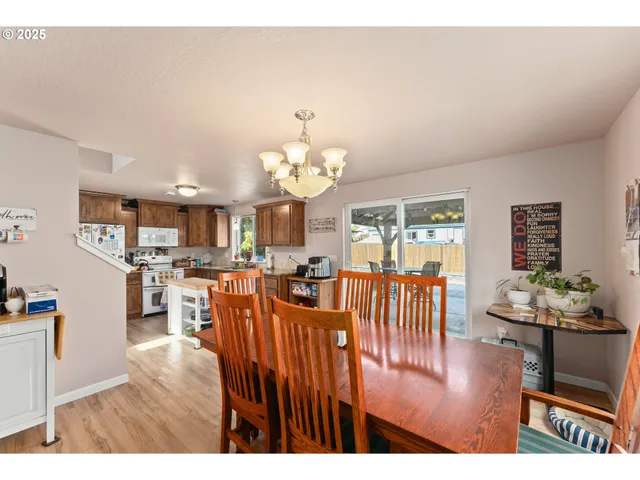 a view of a dining room with furniture and chandelier