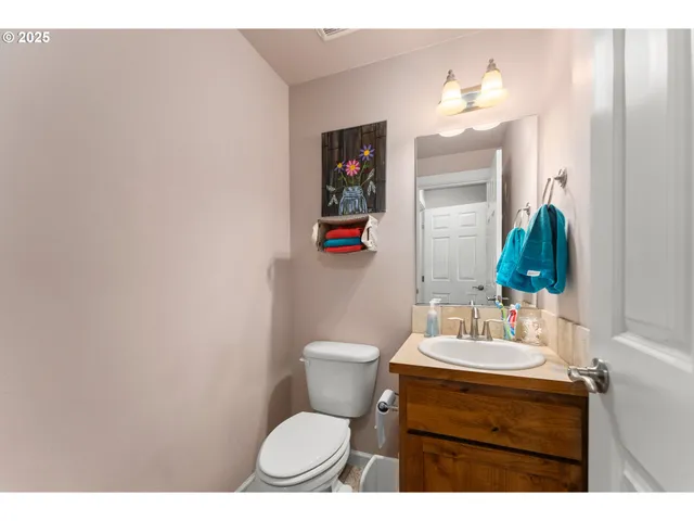 a bathroom with a toilet a sink and mirror