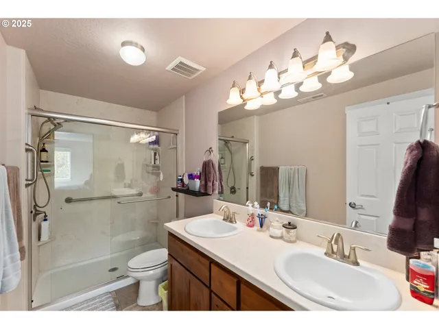 a bathroom with a sink vanity mirror and toilet